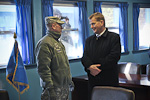  President Niinistö viewing the negotiation room, which is located squarely on the border between South and North Korea. North Korean soldiers observe from the other side of the window. Copyright © Office of the President of the Republic of Finland