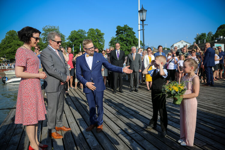 Vastaanottamassa Naantalin kaupungin johtoa. Kuvassa kaupunginvaltuuston puheenjohtaja Toni Forsblom sekä Merimaskun koulun oppilaat Lumi Mäki ja Jeremias Randell, jotka ojensivat kukkia rouva Haukiolle. Kuva: Katri Makkonen/Tasavallan presidentin kanslia