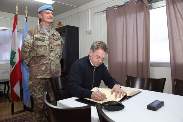 Presidenten skriver i lägrets gästbok. Copyright © Republikens presidents kansli 